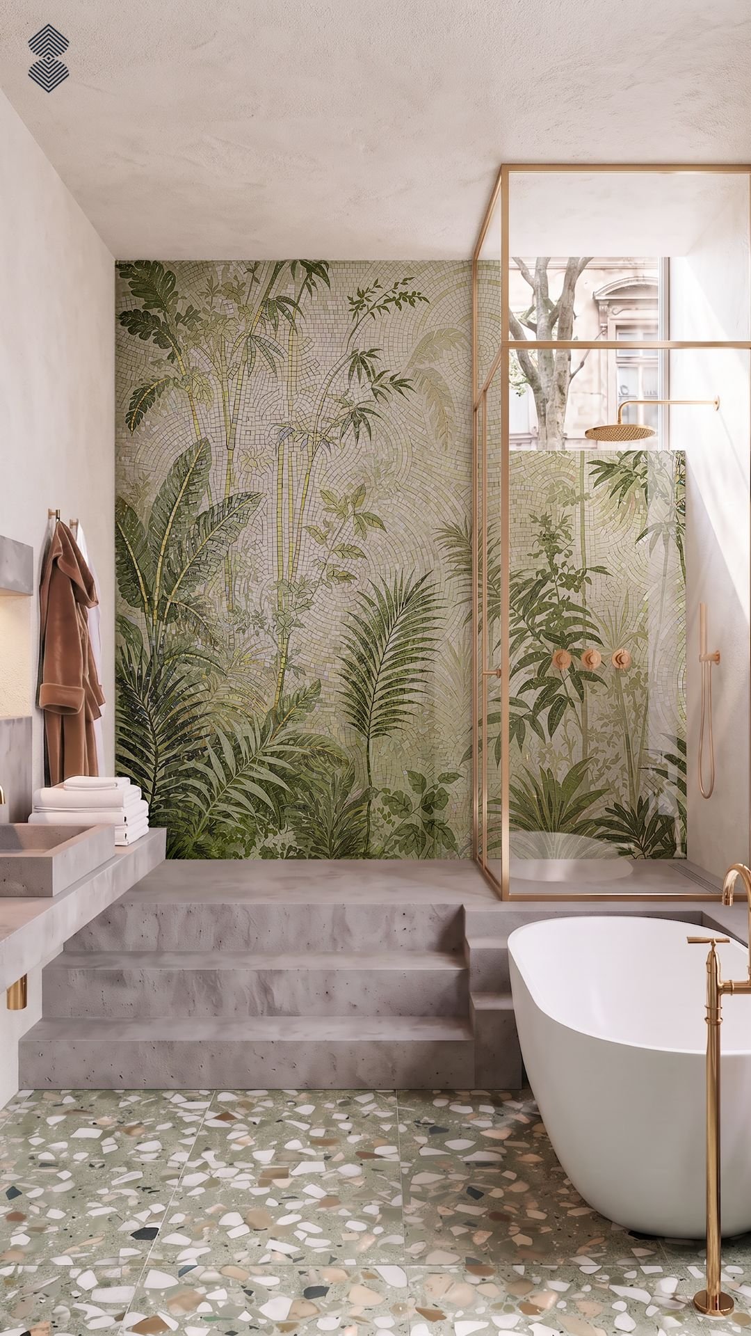 A modern bathroom with terrazzo flooring, a white tub with gold fixtures, and a glass shower area backed by a large-scale green mosaic wall depicting lush tropical jungle foliage.