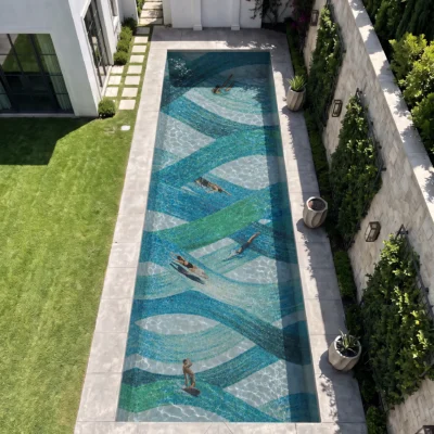 Luxury glass mosaic pool featuring flowing turquoise, blue, green and white wave patterns handcrafted to create a dynamic underwater design.