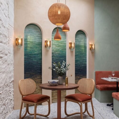 Arched niche filled with a teal-to-indigo ombre wave mosaic panel made of glass tesserae