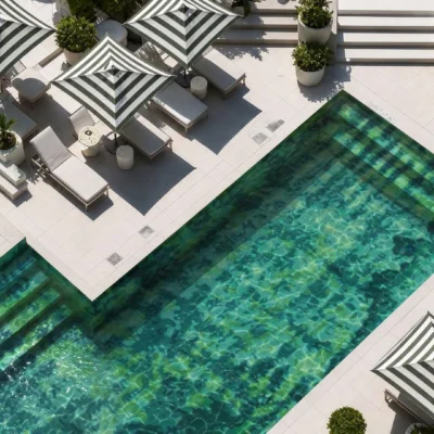 Peridot Estate glass mosaic pool featuring layered emerald, turquoise and aqua tones with a luxurious abstract design and sunlit water.