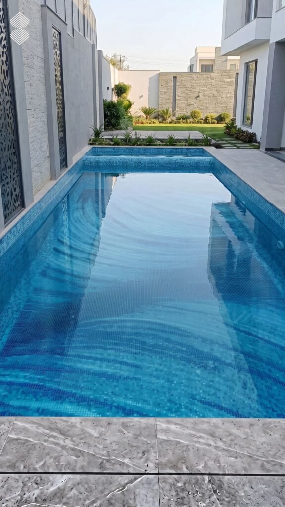 Long lap pool with light blue water and swirling pixel mosaic patterns on the bottom.