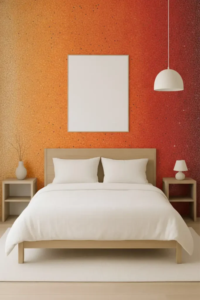 A modern bedroom featuring a warm, textured mosaic accent wall that gradients smoothly from yellow to orange and deep red.