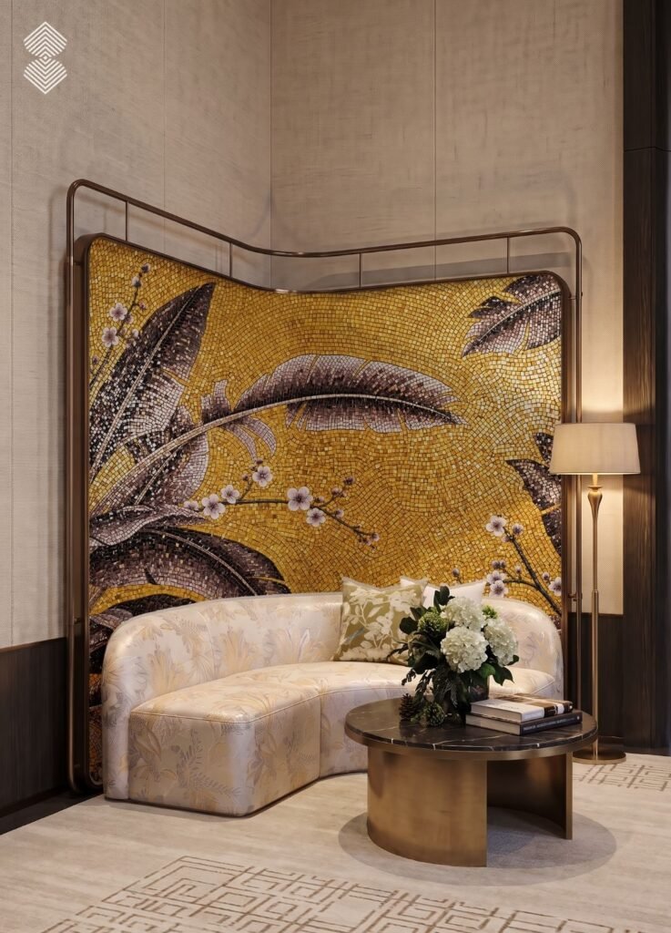 A curved, patterned cream sofa placed in front of a curved room divider featuring a gold mosaic mural with large, dark banana leaves and white blossoms.