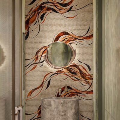 Amber swirl mosaic mural in copper, black, and cream tesserae covering a narrow powder room feature wall