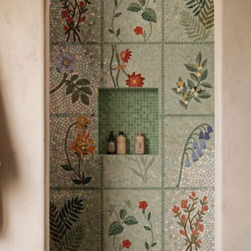 A botanical grid mosaic of flowers and leaves installed as a shower wall panel.