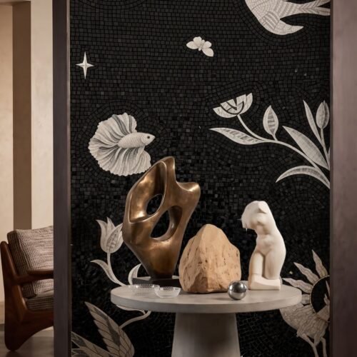 A black and white nature mosaic mural showing birds, fish and tulip stems on a dark feature wall.