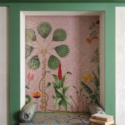 A palm tree mosaic mural with fan leaves and tropical flowers set against a pink background in an arched niche.