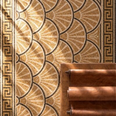 A roman fan mosaic floor panel with gold and cream scalloped shell patterns inside a Greek key border