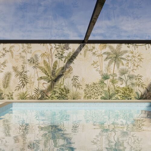 A tropical botanical wall mosaic mural in muted green and cream tones installed along a poolside wall.